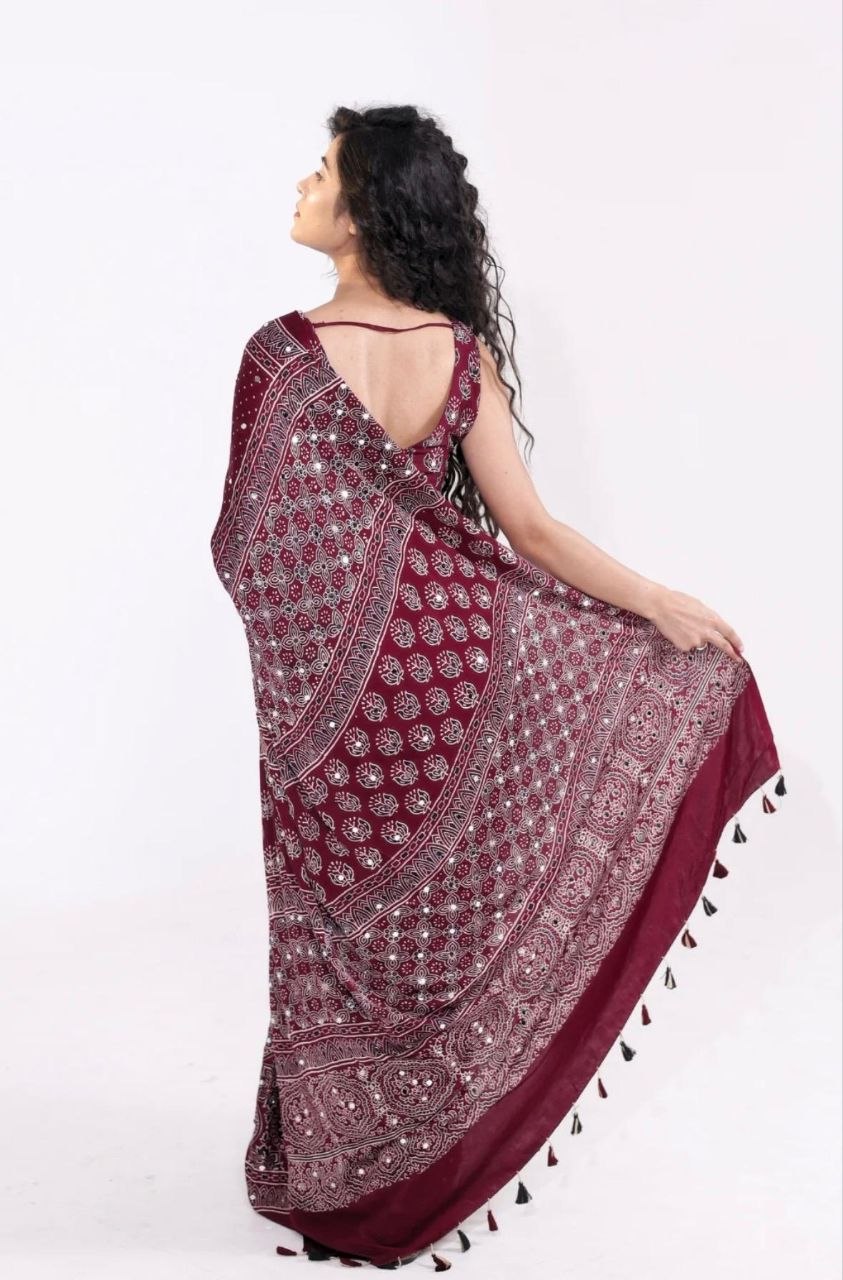 Maroon Ajrakh Print Mirror Work Saree With Designer Border & Tassels With Matching Blouse Piece