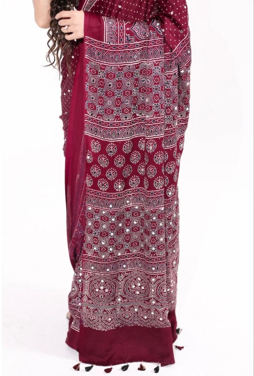 Maroon Ajrakh Print Mirror Work Saree With Designer Border & Tassels With Matching Blouse Piece