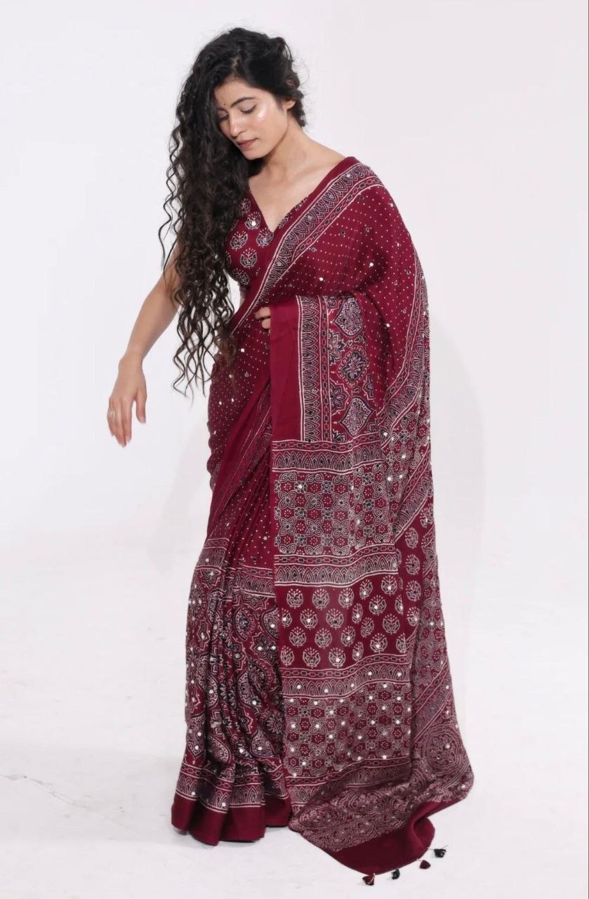 Maroon Ajrakh Print Mirror Work Saree With Designer Border & Tassels With Matching Blouse Piece